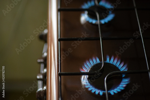 Burning blue flame of gas on the stove. Gas-burner