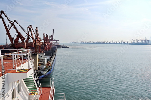 Type of cargo terminal and cranes, berths for transshipment of bulk cargo iron ore. Port Rizhao, China. photo