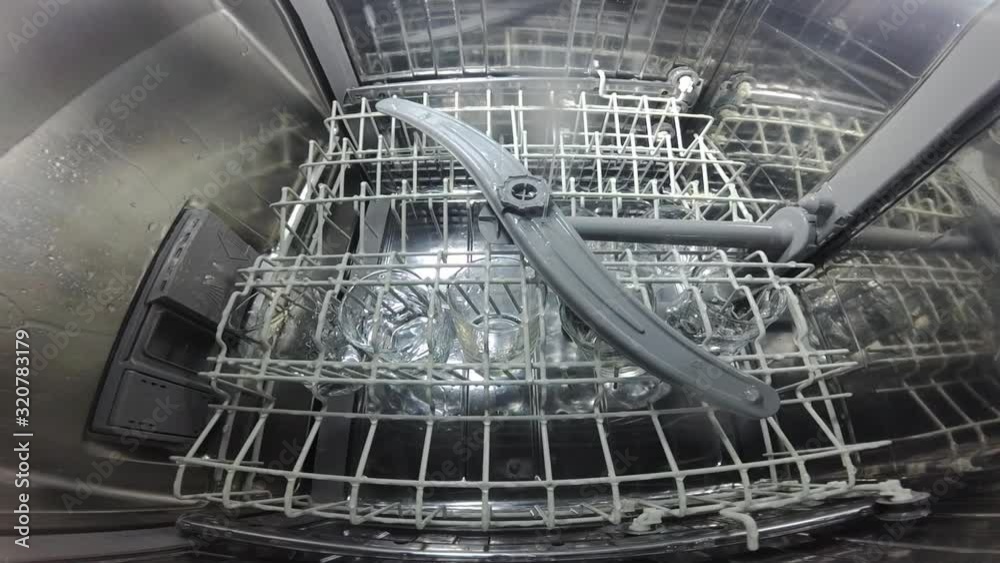 Slow motion. The master repairs the dishwasher and checks the operation