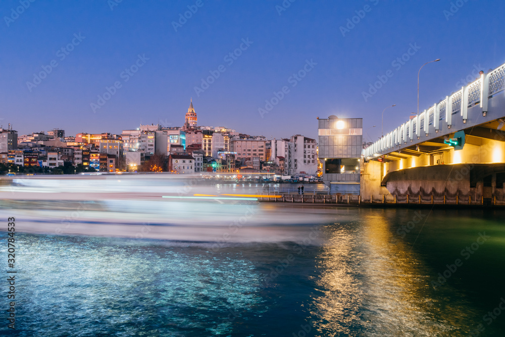 Istanbul, Turkey - Jan 10, 2020: Ferry boat in Golden Horn at the Galata Bridge with Galata Tower in background, Istanbul, Turkey, Europe