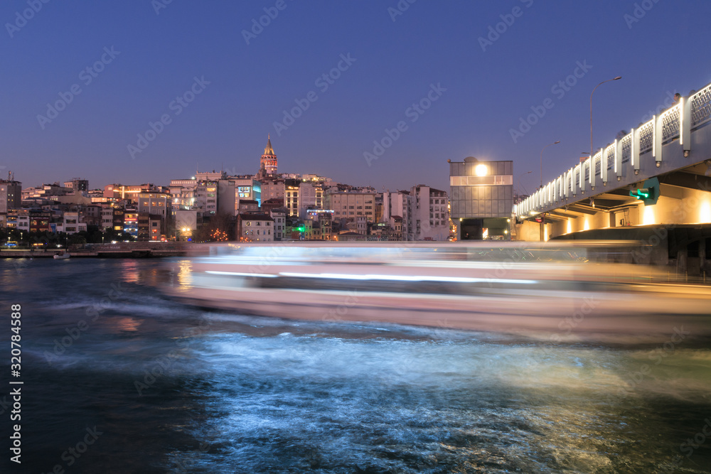 Istanbul, Turkey - Jan 10, 2020: Ferry boat in Golden Horn at the Galata Bridge with Galata Tower in background, Istanbul, Turkey, Europe
