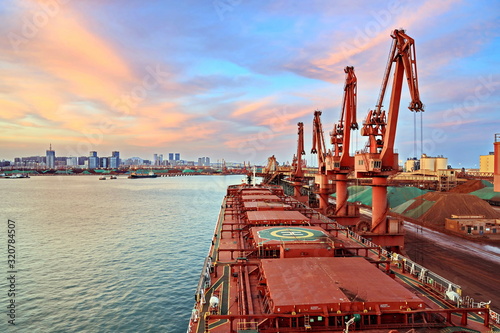 Type of cargo terminal and cranes, berths for transshipment of bulk cargo iron ore. Port Rizhao, China.