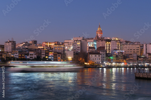 Istanbul, Turkey - Jan 10, 2020: Ferry boat in Golden Horn with Galata Tower in background, Istanbul, Turkey, Europe