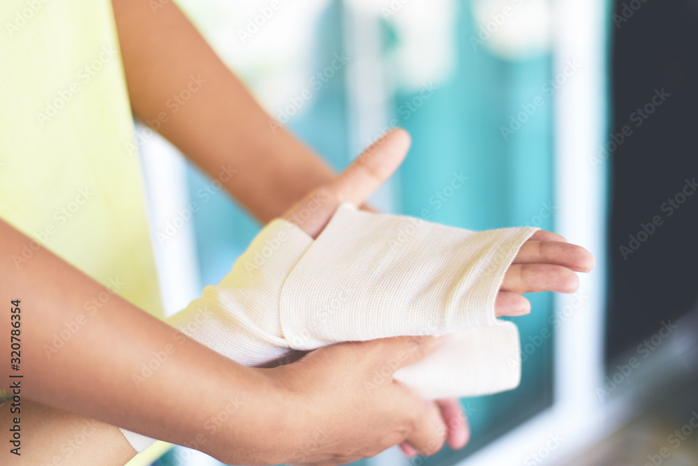 Hand wound bandaging arm by nurse - first aid wrist injury health care and medicine concept Hand wound bandaging arm by nurse - first aid wrist injury health care and medicine concept
