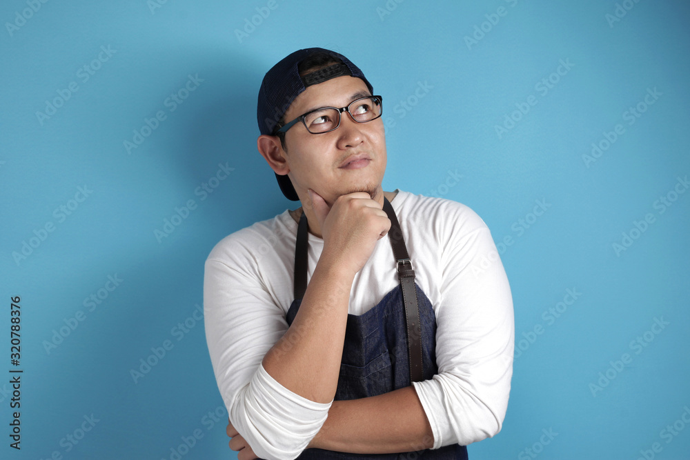 Male Asian Chef or Waiter Thinking Something Male Asian Chef or Waiter Thinking Something