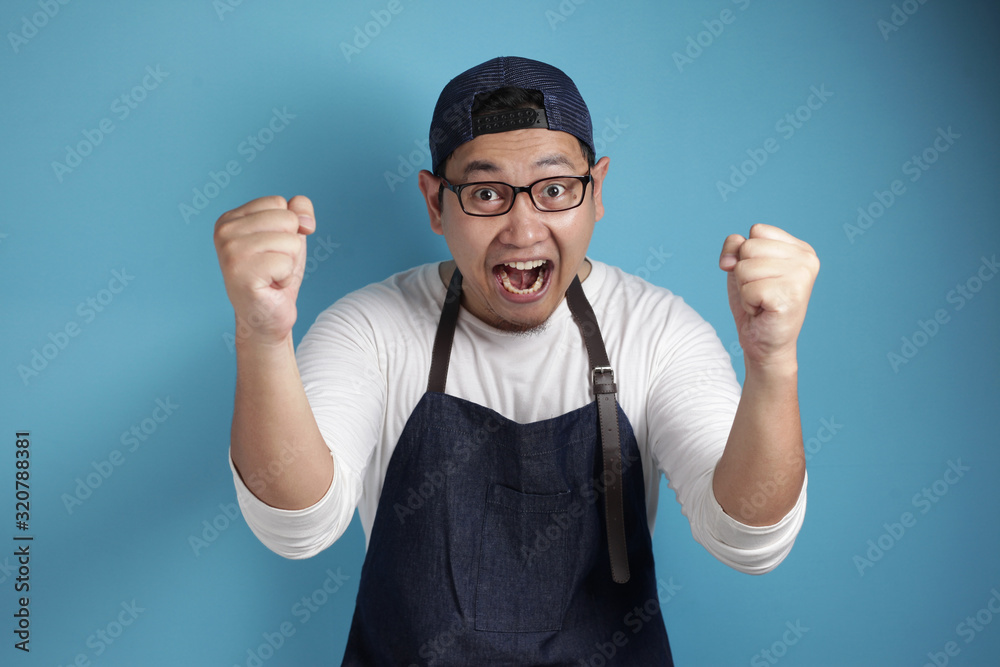 Naklejka premium Happy Proud Asian Chef or Waiter Shows Winning Gesture