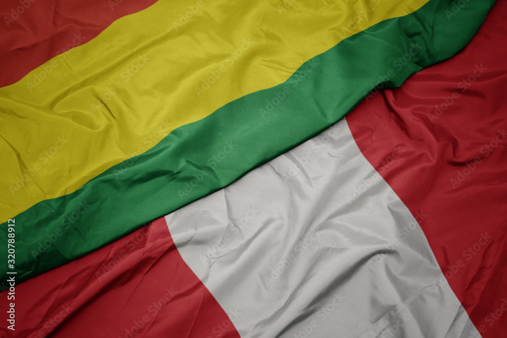 Fototapeta premium waving colorful flag of peru and national flag of bolivia.