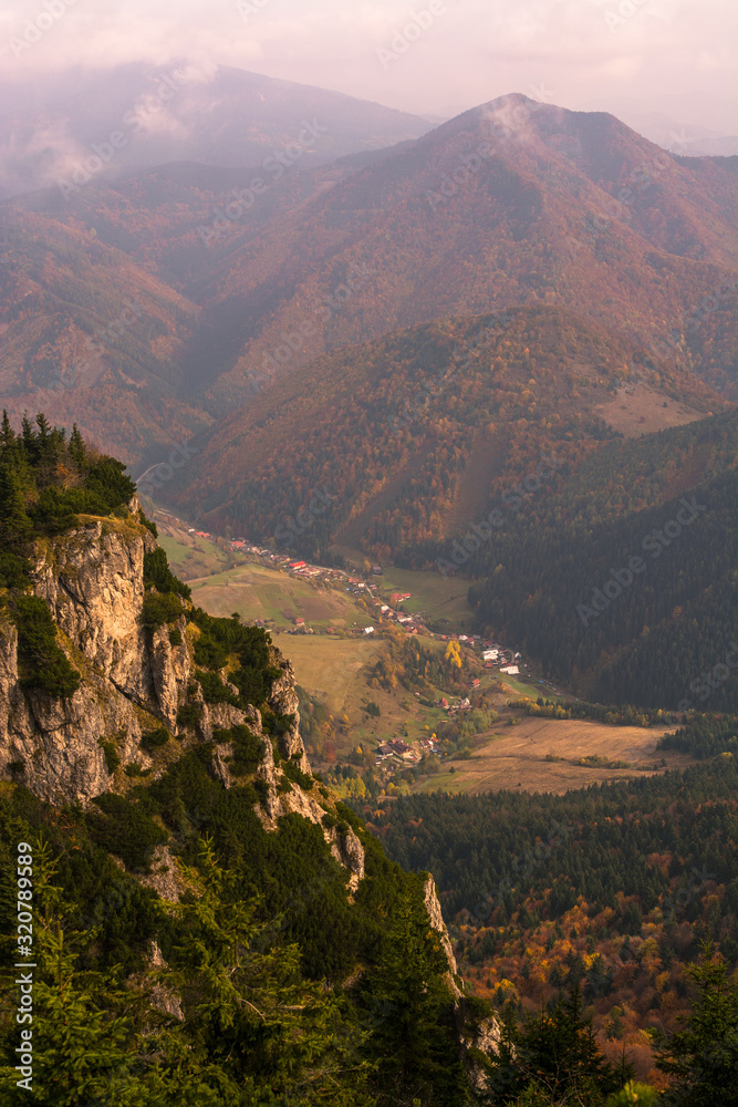 A picturesque village in a valley between mountains on autumn