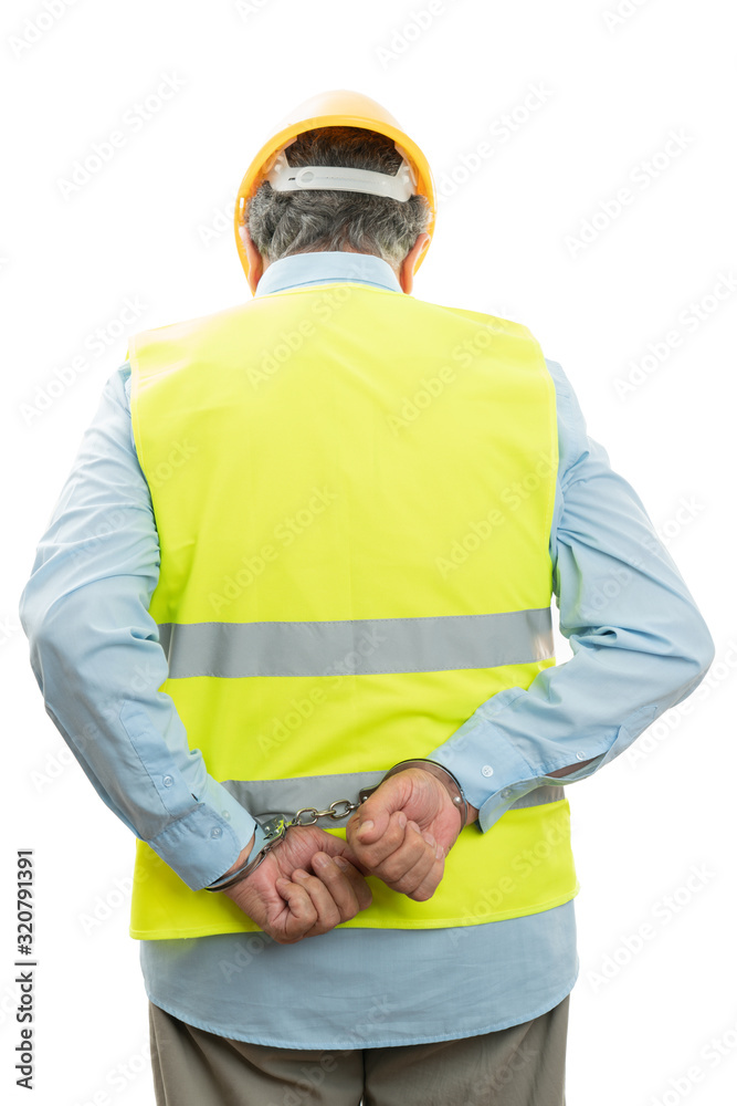 Architect with handcuffs behind back Architect with handcuffs behind back