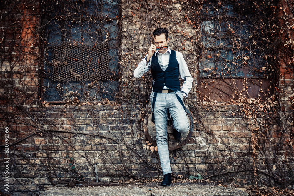 Retro-styled man with sunglasses while leaning on a wall. Retro-styled man with sunglasses while leaning on a wall.