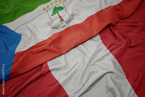 waving colorful flag of peru and national flag of equatorial guinea.
