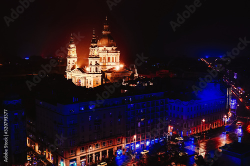 Beautiful night view from air to St. Stephen's Basilica - Church in Budapest, Hungary. Beautiful evening or night scene of illuminating ancient architecture