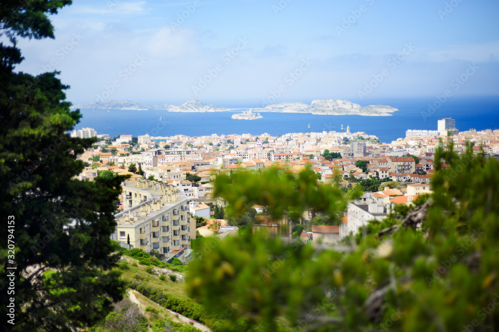 Panoramic view of Marseille, Provence, France in summer day time with famous prison If castle on background. Rooftops of Marseille old town capital of Provence with sea on background.