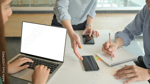 Business team briefed the concepts before the meeting with customers at the modern office equipped with laptop computer. photo