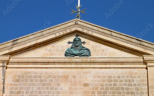 Bust of Christ at the top of St John's Co-cathedral in Valletta, Malta. The wording of 