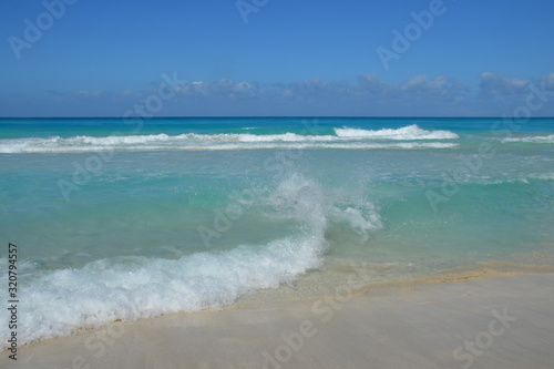 The sea rushes in waves on the sandy shore. Daylight