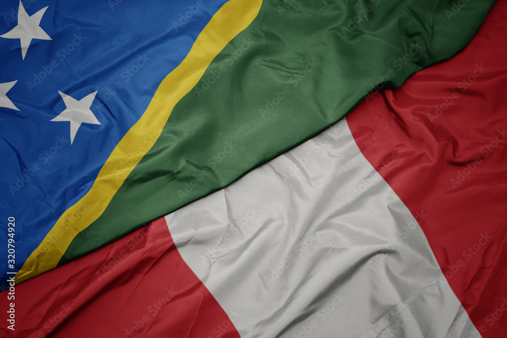 waving colorful flag of peru and national flag of Solomon Islands .