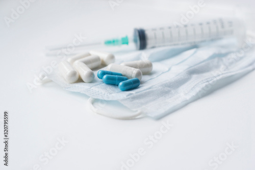 tablets from the flu and medical mask and syringe. Stop virus