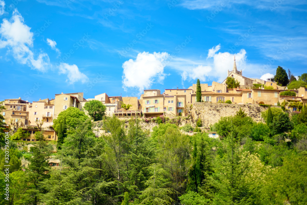 View of old traditional french small provencal village Bonnieux in sunny day with blue sky on background. Popular tourist destination Provence-Alpes-Cote Azure region. Vacations in Provence