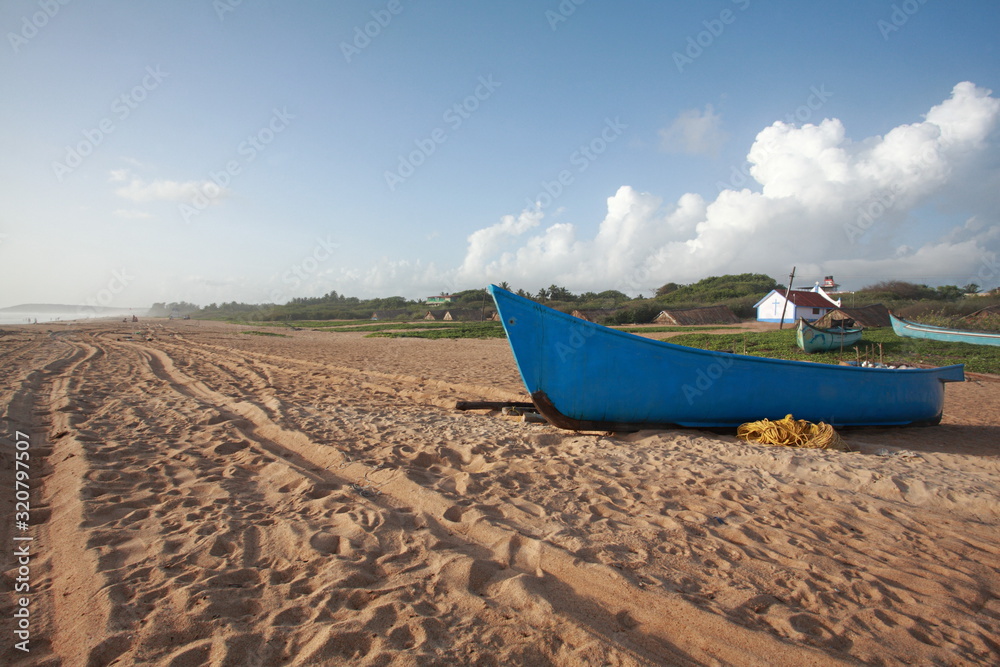 Fishing boat on Candolim beach, Goa, India Fishing boat on Candolim beach, Goa, India