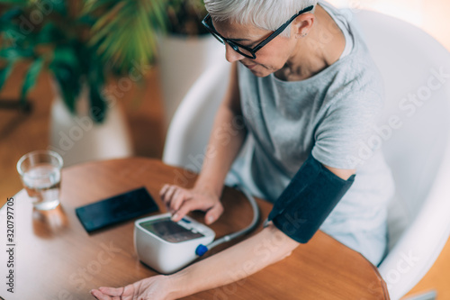 Senior Woman Measuring Blood Pressure
