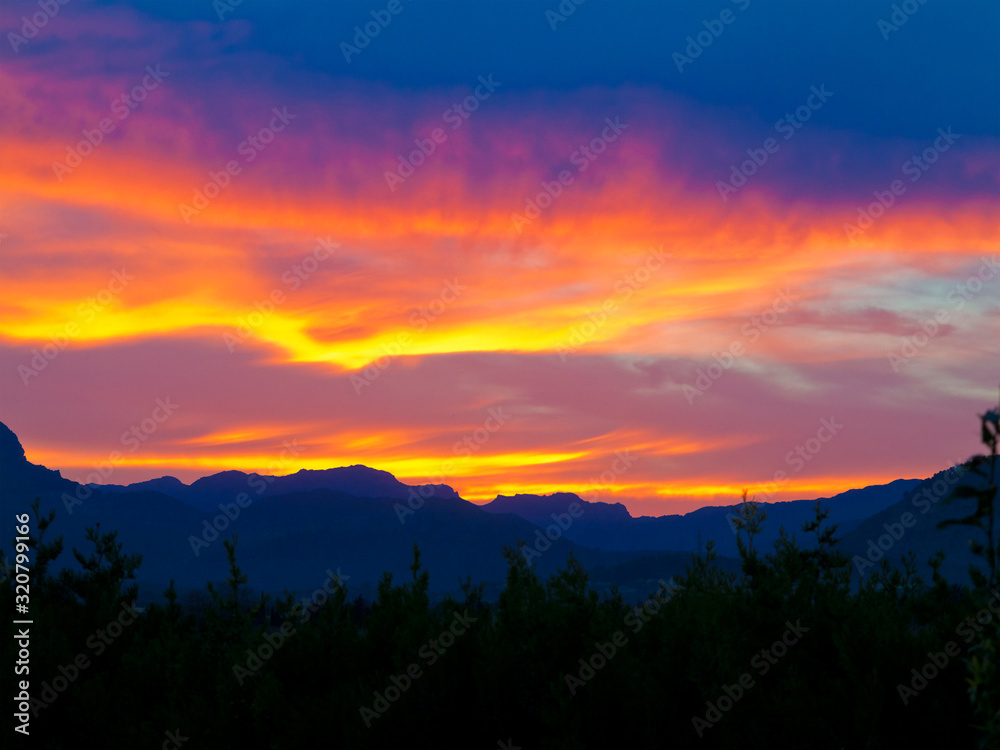 beautiful sunset with the landscape of majorca with the silhouette of the tramuntana mountains in the background