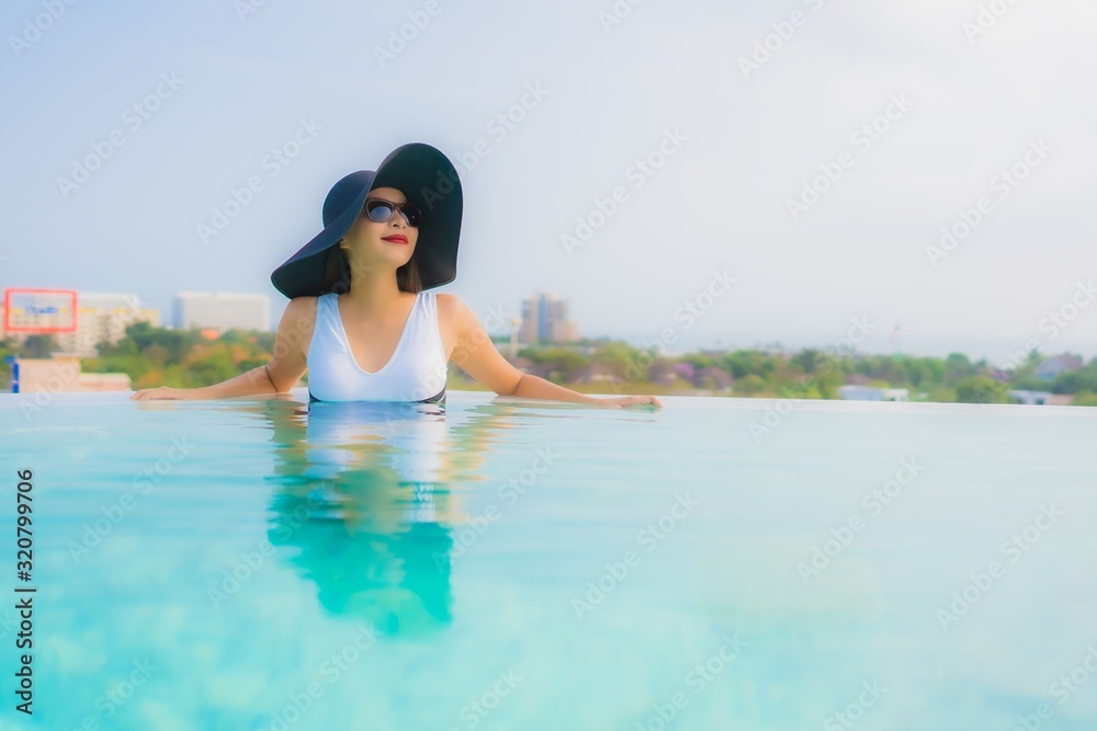 Portrait beautiful young asian woman happy smile relax around outdoor swimming pool in hotel resort Portrait beautiful young asian woman happy smile relax around outdoor swimming pool in hotel resort
