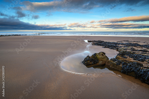 Rocks and sand on Cocklawburn Beach, a rural beach within Northumberland Coast Area of Outstanding Natural Beauty (AONB), located just south of Berwick-upon-Tweed 