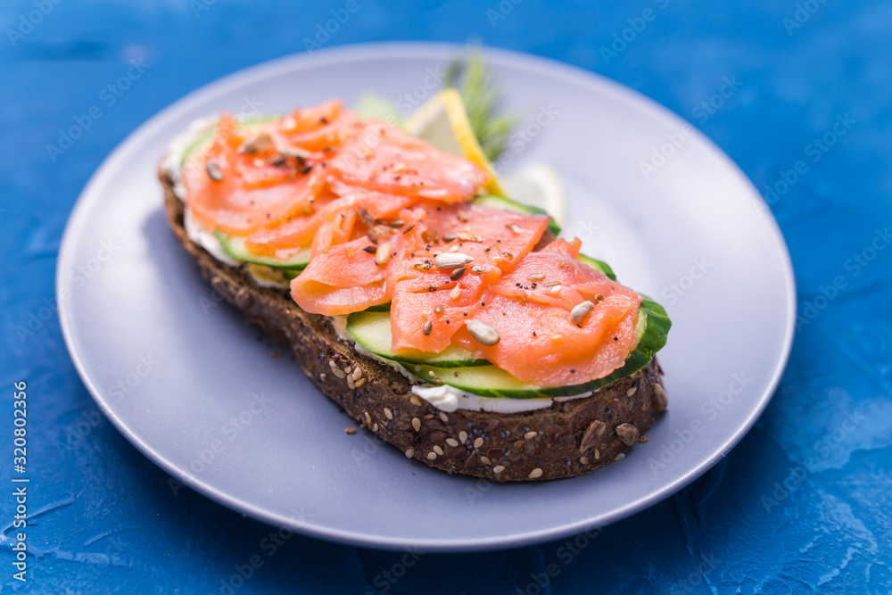Sandwich with smoked salmon and cucumber. Concept for healthy nutrition. Sandwich with smoked salmon and cucumber. Concept for healthy nutrition.