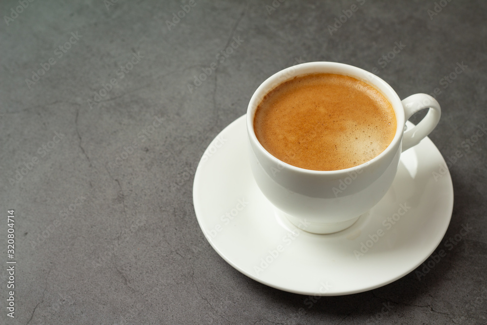 black coffee in a white cup on a black background close-up black coffee in a white cup on a black background close-up