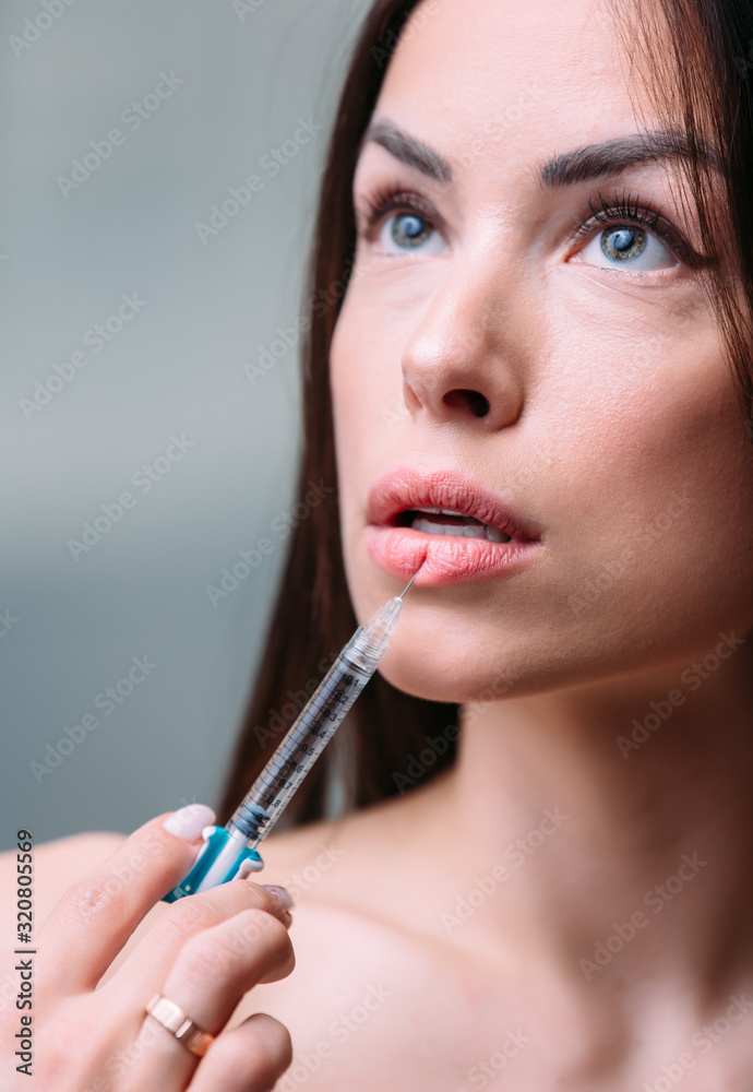 woman beautiful mouth and lips gets an injection. Increase the lips by hyaluronic acid woman beautiful mouth and lips gets an injection. Increase the lips by hyaluronic acid