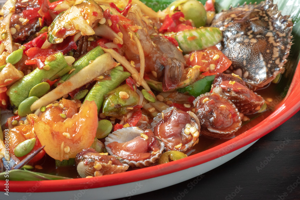 thai seafood salad mixed with Papaya, chopped on colorful tray thai seafood salad mixed with Papaya, chopped on colorful tray