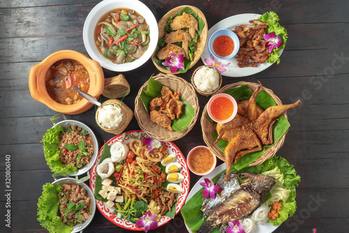 mixed thai isan food on black table