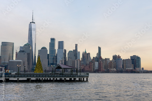 Lower Manhattan New York City Skyline seen from Jersey City with a Christmas Tree during a Sunset