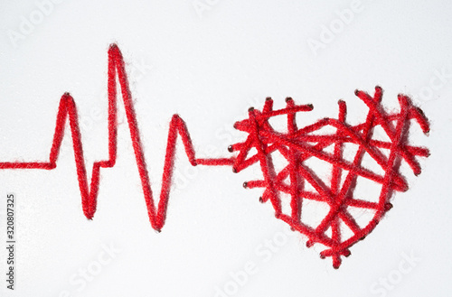heart with pulse with drops made of red thread Valentine's Day love on a white background. copy space