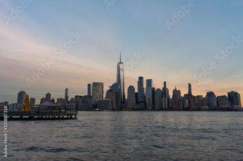 Lower Manhattan New York City Skyline seen from Jersey City with a Christmas Tree during a Sunset