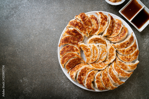 Obraz na plátně fried gyoza or dumplings snack with soy sauce