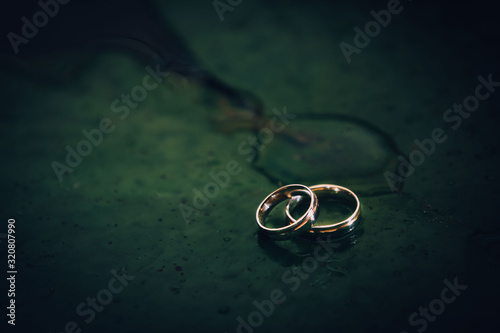 wedding rings on a black background