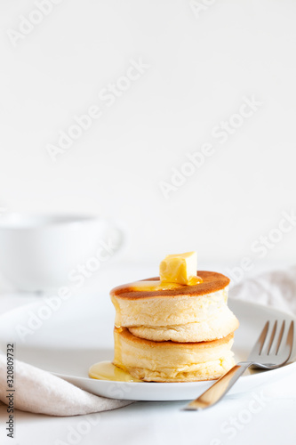 Canvastavla Fluffy Japan souffle pancakes, hotcakes with butter and maple syrup or honey sauces on light white background with copy space