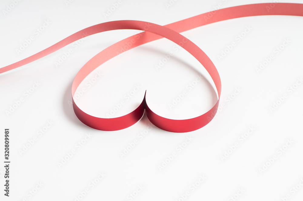 Red heart shaped ribbon isolated on white background with copy space Red heart shaped ribbon isolated on white background with copy space