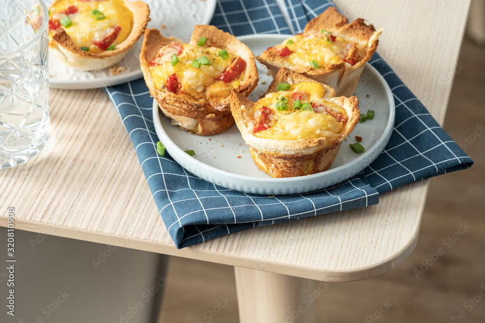 Baked egg, ham, tomato and toast cup for breakfast brunch. Baked egg, ham, tomato and toast cup for breakfast brunch.
