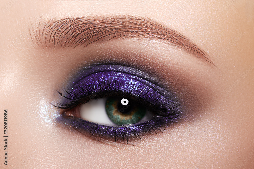 Obraz premium Closeup Macro of Woman Face with Purple Eyes Makeup. Fashion Celebrate Makeup, Glowy Clean Skin, perfect Shapes of Brows