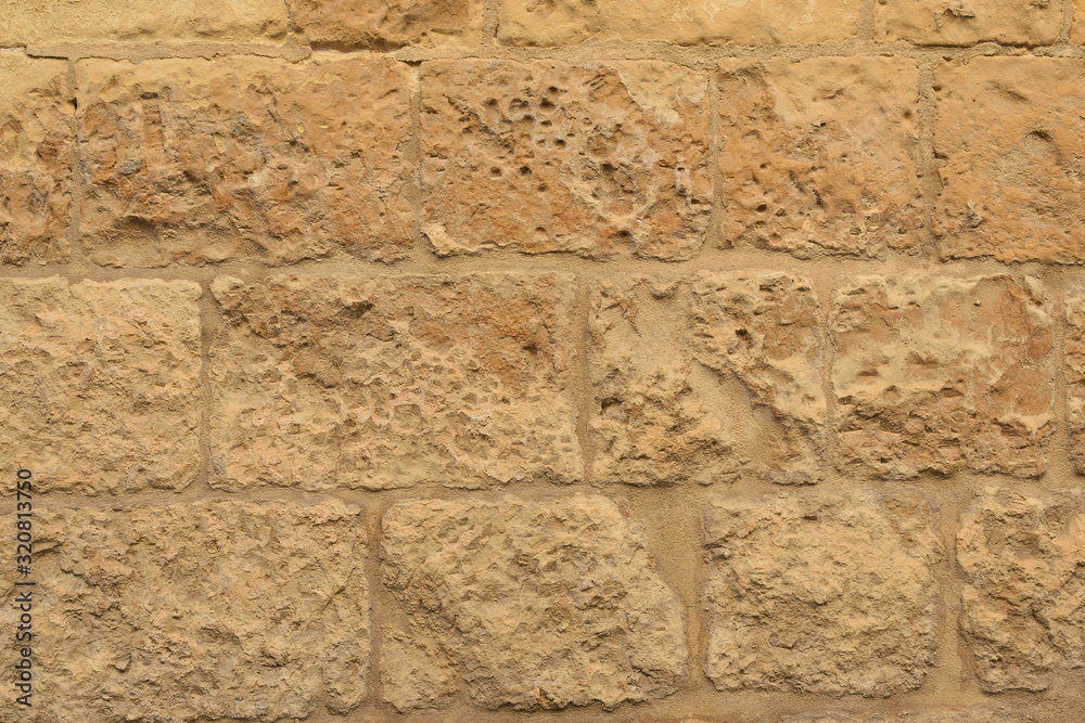 Limestone wall of a traditional medieval Maltese house Lija village, Malta, background, texture