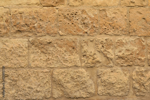 Limestone wall of a traditional medieval Maltese house Lija village, Malta, background, texture photo