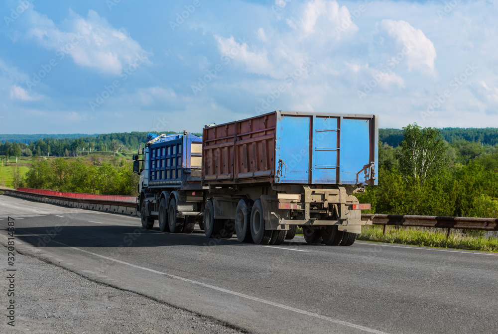 Truck with a Trailer Carries Goods