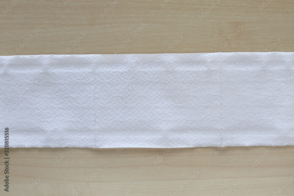 Roll of toilet paper or tissue on wooden background Roll of toilet paper or tissue on wooden background