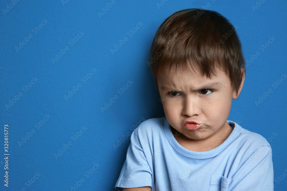 Portrait of emotional little boy on blue background Portrait of emotional little boy on blue background