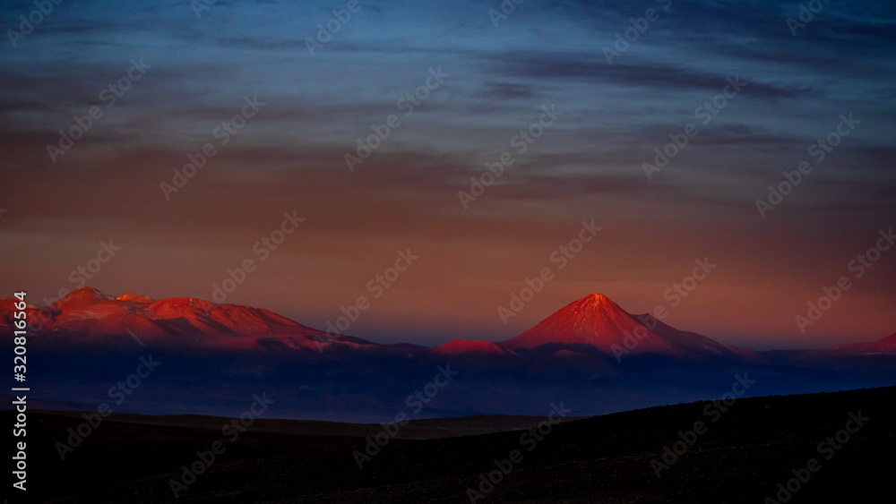 Sunset illuminates Sairecabur and Licancabur volcanoes, Atacama Desert Antofagasta Andes Chile