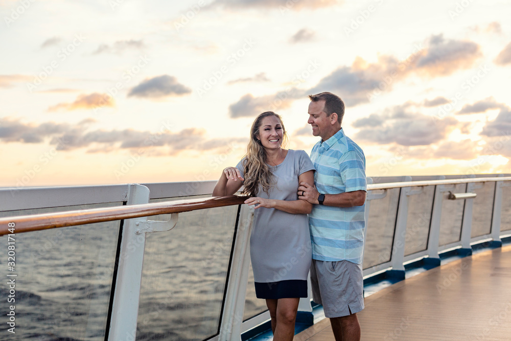 Middle aged couple enjoying a Caribbean Cruise vacation together. Candid photo of a couple holding enjoying their time on board a cruise ship together