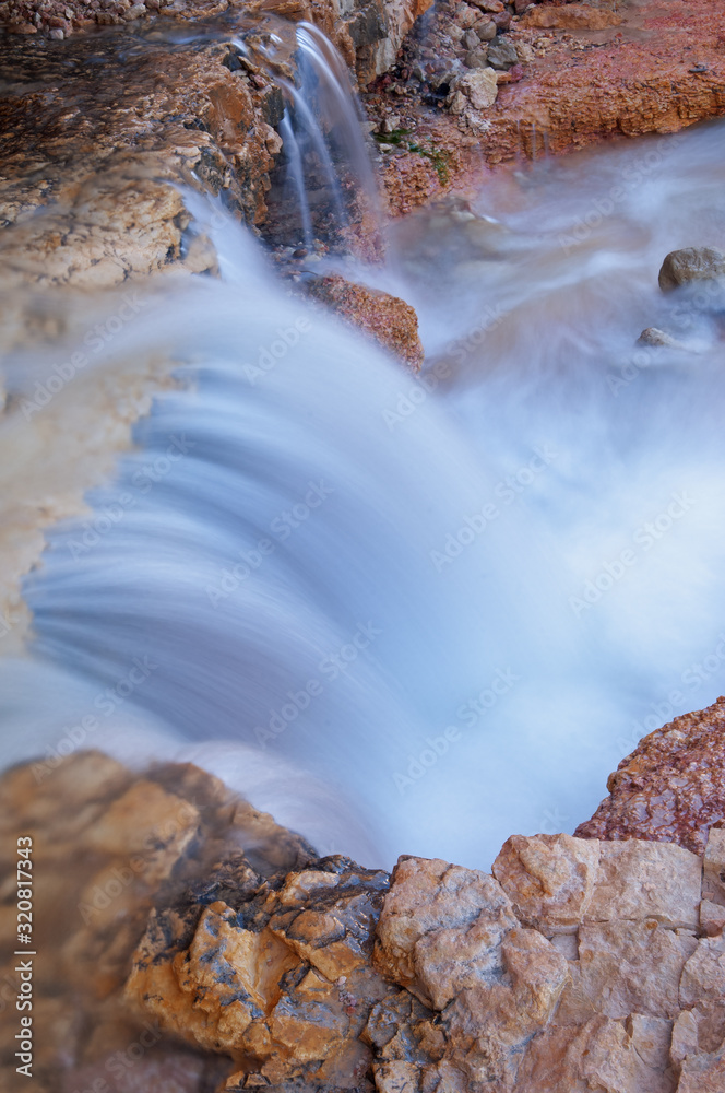 Fototapeta premium Landscape of a waterfall captured with motion blur, Mossy Cave section of Bryce Canyon National Park, Utah, USA